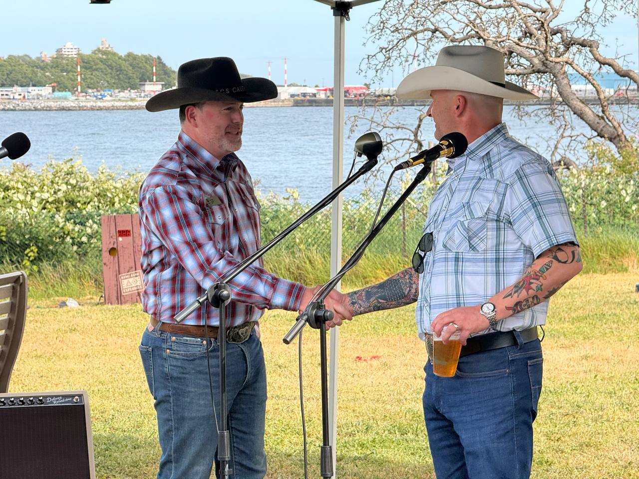 DJ Kelly and Commander Matthew Woodburn shaking hands at the Barn Burner