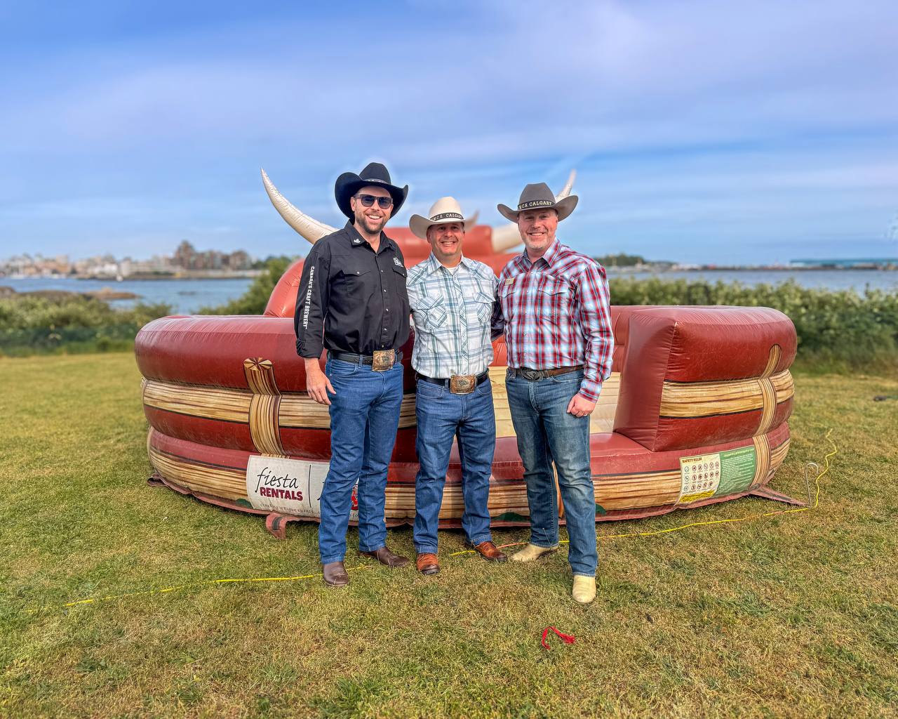 James Costello, Commander Matthew Woodburn, and DJ Kelly at the mechanical bull