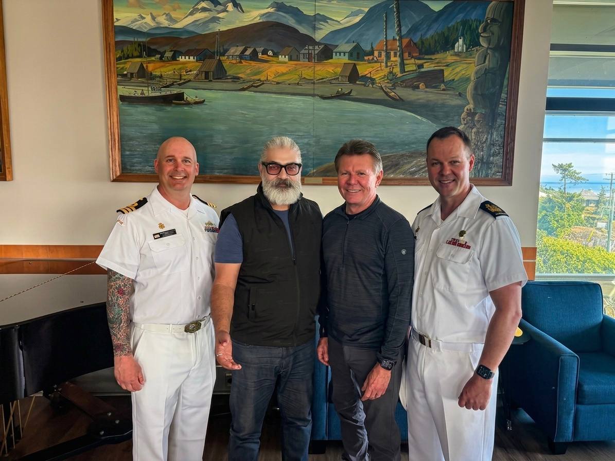 Commander Matthew Woodburn, Raj Taneja, Martin Savidge, and Coxswain Mark Stevens at the Wardroom reception